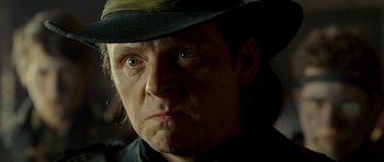 Movie still from “The World's End” (2013), directed by Edgar Wright – A person wearing a hat and looking at the camera; Close Up shot, Low angle