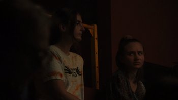 Movie still from “Theater Camp” (2023), directed by Molly Gordon – Two people are standing in a room with a yellow wall; Close Up shot, Over the shoulder angle