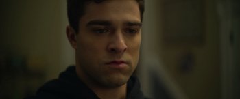 Movie still from “There's Someone Inside Your House” (2021), directed by Patrick Brice – A man's face in a dark room; Close Up shot, Over the shoulder angle