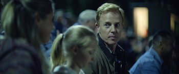 Movie still from “There's Someone Inside Your House” (2021), directed by Patrick Brice – A person looking at something; Close Up shot, Over the shoulder angle