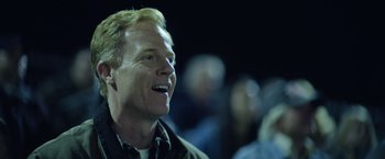 Movie still from “There's Someone Inside Your House” (2021), directed by Patrick Brice – A person smiling at the camera; Close Up shot, Over the shoulder angle