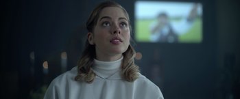 Movie still from “There's Someone Inside Your House” (2021), directed by Patrick Brice – A woman in a white sweater looking up at the sky; Close Up shot, Low angle