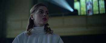 Movie still from “There's Someone Inside Your House” (2021), directed by Patrick Brice – A woman in a white shirt looking up at the sky; Close Up shot, Low angle