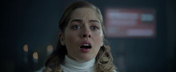 Movie still from “There's Someone Inside Your House” (2021), directed by Patrick Brice – A woman with a surprised look on her face; Close Up shot, Over the shoulder angle