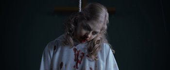 Movie still from “There's Someone Inside Your House” (2021), directed by Patrick Brice – A young girl with blood all over her face; Close Up shot, Low angle