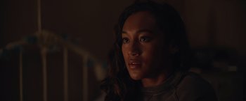 Movie still from “There's Someone Inside Your House” (2021), directed by Patrick Brice – A person with long hair; Close Up shot, Over the shoulder angle