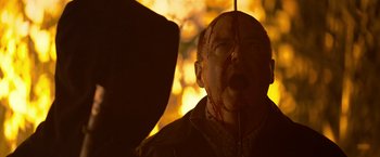 Movie still from “There's Someone Inside Your House” (2021), directed by Patrick Brice – A man with blood all over his face and head; Close Up shot, Low angle