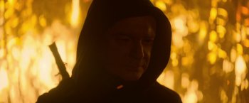 Movie still from “There's Someone Inside Your House” (2021), directed by Patrick Brice – A man in a black hooded sweatshirt is looking at the camera; Close Up shot, Low angle