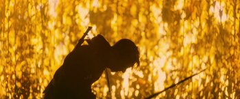 Movie still from “There's Someone Inside Your House” (2021), directed by Patrick Brice – A person is holding a cell phone in their hand; Wide shot, Low angle