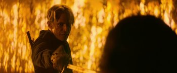 Movie still from “There's Someone Inside Your House” (2021), directed by Patrick Brice – A man with blonde hair is looking into a mirror; Close Up shot, Over the shoulder angle