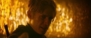 Movie still from “There's Someone Inside Your House” (2021), directed by Patrick Brice – A man's face in front of a yellow background; Close Up shot, Over the shoulder angle