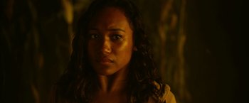 Movie still from “There's Someone Inside Your House” (2021), directed by Patrick Brice – A person with long curly hair; Close Up shot, Over the shoulder angle