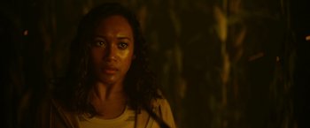 Movie still from “There's Someone Inside Your House” (2021), directed by Patrick Brice – A young woman with long dark hair stares into the camera; Close Up shot, Over the shoulder angle