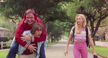 Movie still from “There's Something About Mary” (1998), directed by Bobby Farrelly – A man and a woman walking down a street with a child; Medium shot, Over the shoulder angle