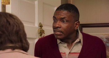 Movie still from “There's Something About Mary” (1998), directed by Bobby Farrelly – A black man in a red and white striped sweater; Close Up shot, Over the shoulder angle