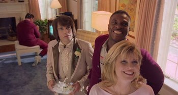 Movie still from “There's Something About Mary” (1998), directed by Bobby Farrelly – A man and two women posing for a picture; Medium shot, Low angle