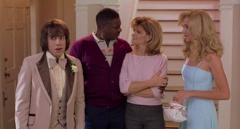 Movie still from “There's Something About Mary” (1998), directed by Bobby Farrelly – A group of people standing next to each other in a room; Medium shot, Over the shoulder angle