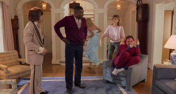 Movie still from “There's Something About Mary” (1998), directed by Bobby Farrelly – A group of people standing in a living room; Wide shot, Over the shoulder angle