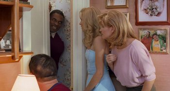 Movie still from “There's Something About Mary” (1998), directed by Bobby Farrelly – Two women and a man in a room with a door open; Medium shot, Over the shoulder angle