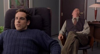 Movie still from “There's Something About Mary” (1998), directed by Bobby Farrelly – Two men sitting in a chair and one man is asleep; Medium shot, Over the shoulder angle