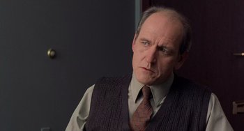 Movie still from “There's Something About Mary” (1998), directed by Bobby Farrelly – An older man wearing a vest and a tie; Close Up shot, Over the shoulder angle