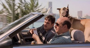 Movie still from “There's Something About Mary” (1998), directed by Bobby Farrelly – Two men and a dog in a car; Medium shot, Over the shoulder angle