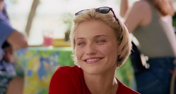 Movie still from “There's Something About Mary” (1998), directed by Bobby Farrelly – A person wearing sunglasses and smiling; Close Up shot, Over the shoulder angle