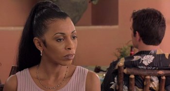 Movie still from “There's Something About Mary” (1998), directed by Bobby Farrelly – A woman sitting in front of another woman in a room; Close Up shot, Over the shoulder angle