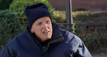 Movie still from “There's Something About Mary” (1998), directed by Bobby Farrelly – A person wearing a jacket and a hat; Close Up shot, Low angle