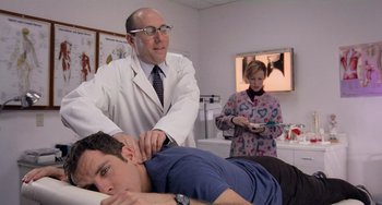 Movie still from “There's Something About Mary” (1998), directed by Bobby Farrelly – A man is getting his head examined by a doctor; Medium shot, Low angle