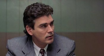 Movie still from “There's Something About Mary” (1998), directed by Bobby Farrelly – A person wearing a suit and tie; Close Up shot, Over the shoulder angle