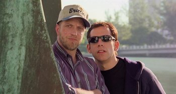 Movie still from “There's Something About Mary” (1998), directed by Bobby Farrelly – A couple of men standing next to each other near a tree; Close Up shot, Low angle