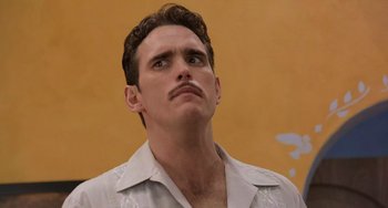 Movie still from “There's Something About Mary” (1998), directed by Bobby Farrelly – A man with a mustache looking up at the sky; Close Up shot, Low angle