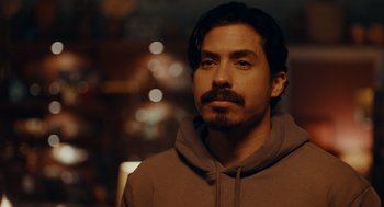 Movie still from “There's Something Wrong with the Children” (2023), directed by Roxanne Benjamin – A person wearing a hoodie; Close Up shot, Over the shoulder angle