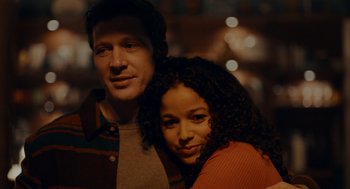 Movie still from “There's Something Wrong with the Children” (2023), directed by Roxanne Benjamin – A man and a woman posing for a picture; Close Up shot, Low angle