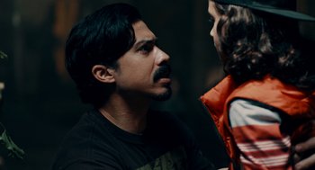 Movie still from “There's Something Wrong with the Children” (2023), directed by Roxanne Benjamin – A man and a child looking at one another; Close Up shot, Over the shoulder angle