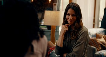 Movie still from “There's Something Wrong with the Children” (2023), directed by Roxanne Benjamin – A woman sitting in front of another woman in a room; Close Up shot, Over the shoulder angle
