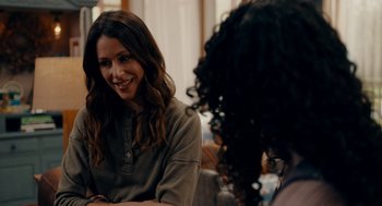 Movie still from “There's Something Wrong with the Children” (2023), directed by Roxanne Benjamin – Two women sitting at a table talking to each other; Close Up shot, Over the shoulder angle