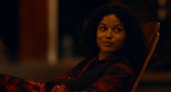 Movie still from “There's Something Wrong with the Children” (2023), directed by Roxanne Benjamin – A person sitting in a chair; Close Up shot, Over the shoulder angle