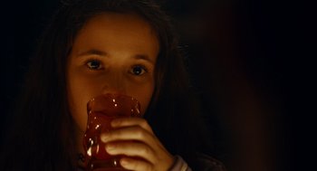 Movie still from “There's Something Wrong with the Children” (2023), directed by Roxanne Benjamin – A woman holding a cup of coffee in her hands; Close Up shot, Over the shoulder angle