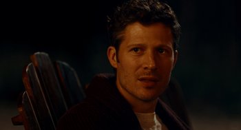 Movie still from “There's Something Wrong with the Children” (2023), directed by Roxanne Benjamin – A person wearing a sweater; Close Up shot, Over the shoulder angle