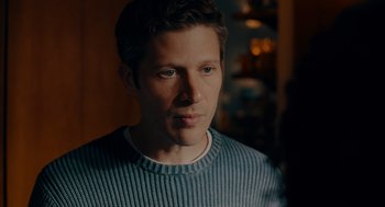Movie still from “There's Something Wrong with the Children” (2023), directed by Roxanne Benjamin – A person wearing a sweater; Close Up shot, Over the shoulder angle