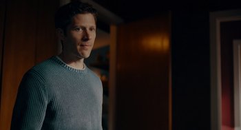 Movie still from “There's Something Wrong with the Children” (2023), directed by Roxanne Benjamin – A man standing in front of a wooden door; Medium shot, Over the shoulder angle