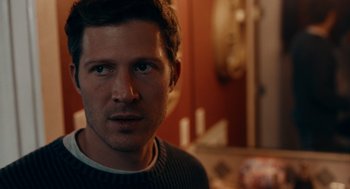 Movie still from “There's Something Wrong with the Children” (2023), directed by Roxanne Benjamin – A person wearing a sweater; Close Up shot, Over the shoulder angle