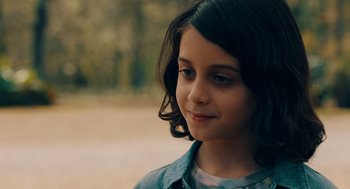 Movie still from “There's Something Wrong with the Children” (2023), directed by Roxanne Benjamin – A young girl is looking to her left; Close Up shot, Over the shoulder angle