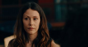 Movie still from “There's Something Wrong with the Children” (2023), directed by Roxanne Benjamin – A person with long brown hair; Close Up shot, Over the shoulder angle