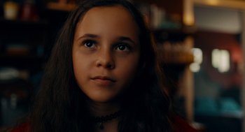 Movie still from “There's Something Wrong with the Children” (2023), directed by Roxanne Benjamin – A young girl is looking into the distance; Close Up shot, High angle