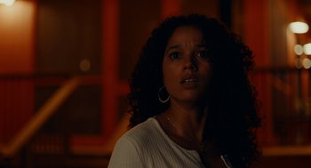 Movie still from “There's Something Wrong with the Children” (2023), directed by Roxanne Benjamin – A person with curly hair; Close Up shot, Low angle