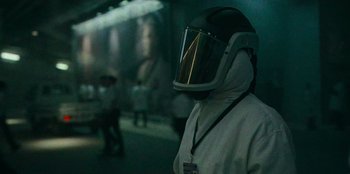 Movie still from “They Cloned Tyrone” (2023), directed by Juel Taylor – A person wearing a white suit and a helmet; Medium shot, Over the shoulder angle