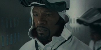 Movie still from “They Cloned Tyrone” (2023), directed by Juel Taylor – A person wearing a helmet; Close Up shot, Low angle